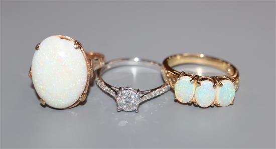 A modern 9ct gold and diamond cluster ring, a 9ct gold and three stone white opal ring and one other 9ct opal ring.